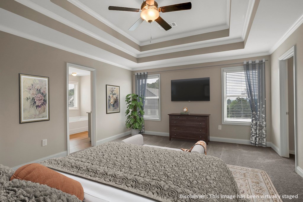 a bedroom with a large bed and a ceiling fan