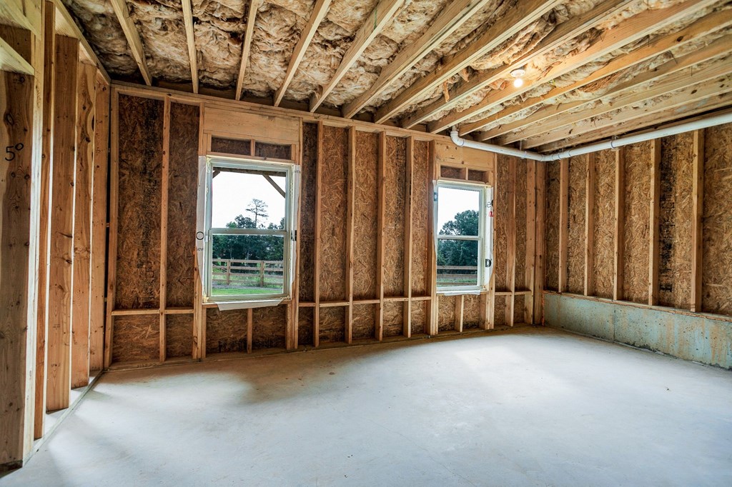 a room being remodeled with wood studs and a window