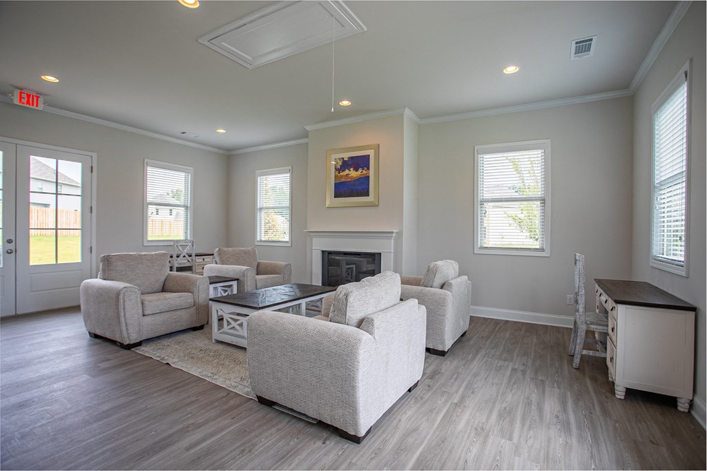a living room with couches and chairs and a fireplace