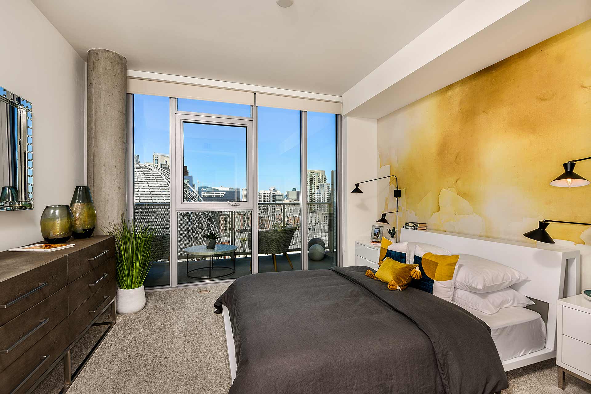 master bedroom with large windows at K1 Apartments, San Diego, CA