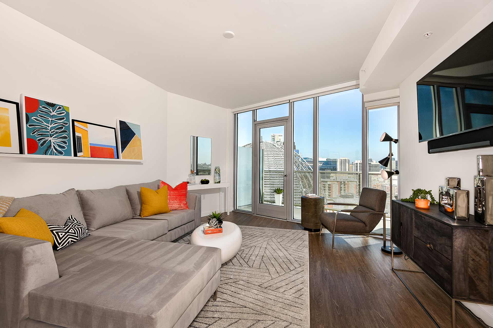 a living room with a gray couch and a large window