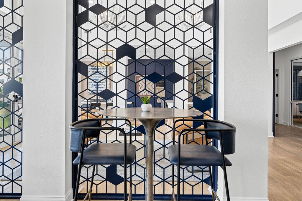 A dining room with a hexagonal patterned wall.