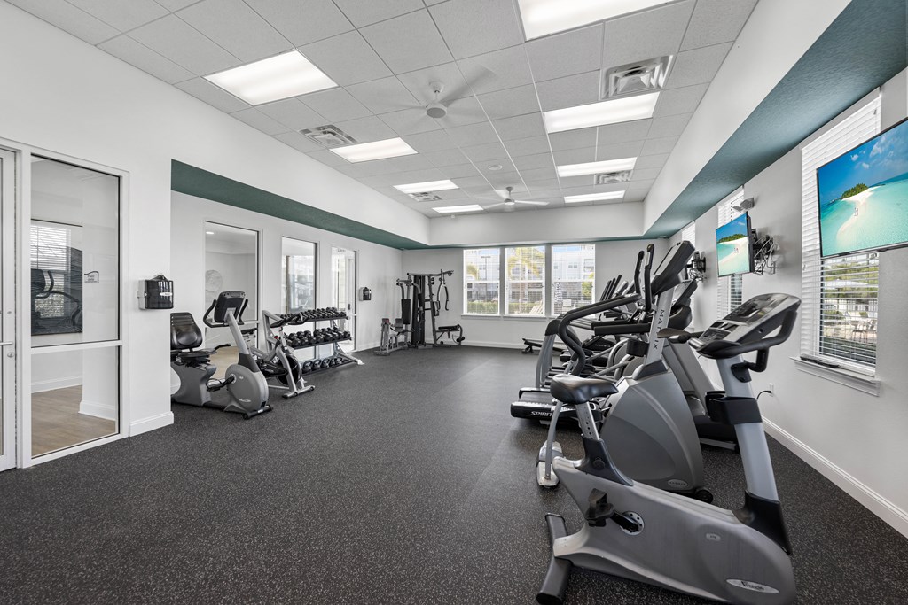 A spacious gym with a variety of exercise equipment.