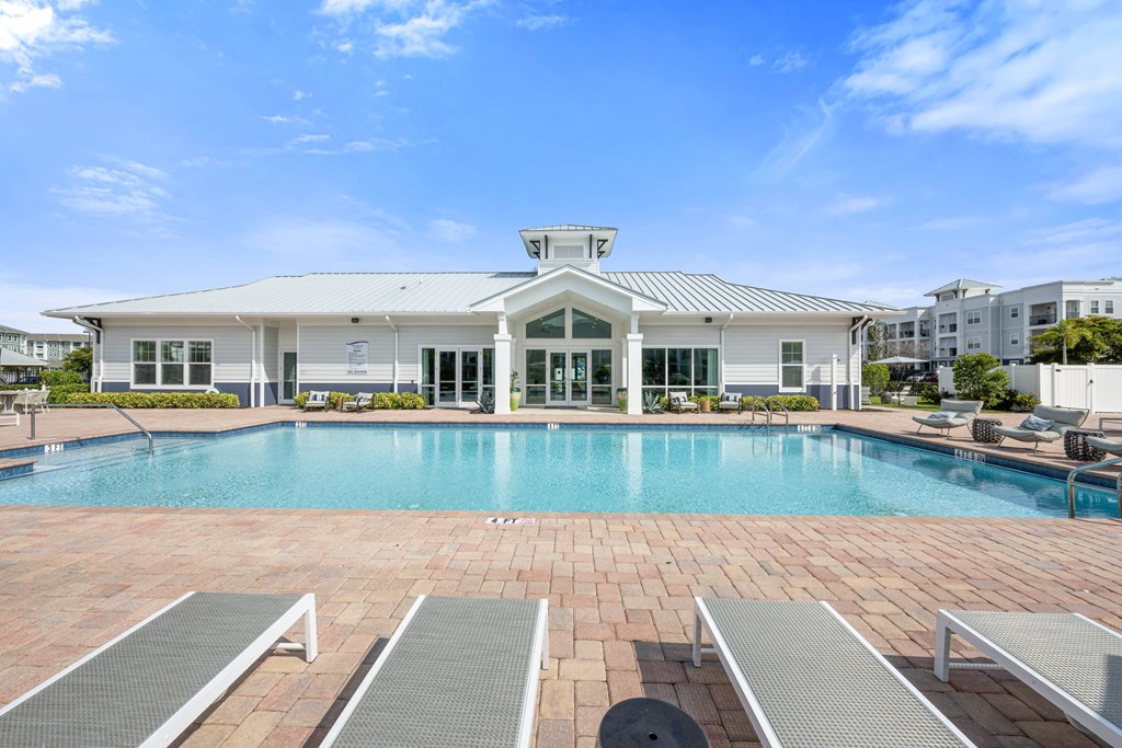 A large swimming pool with a building in the background.