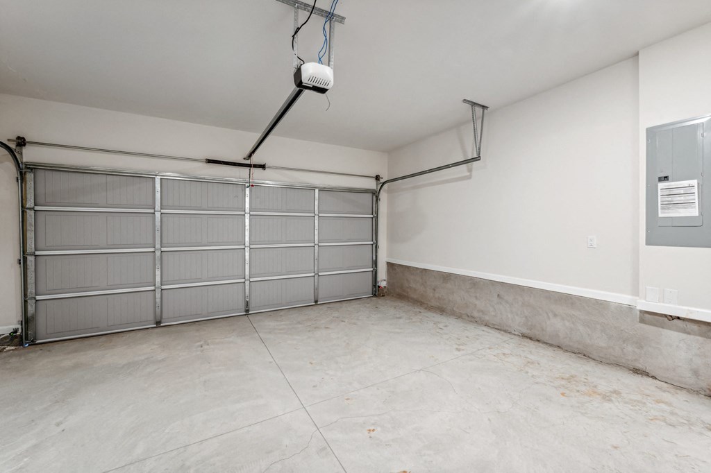 the interior of a garage with a white wall and a garage door