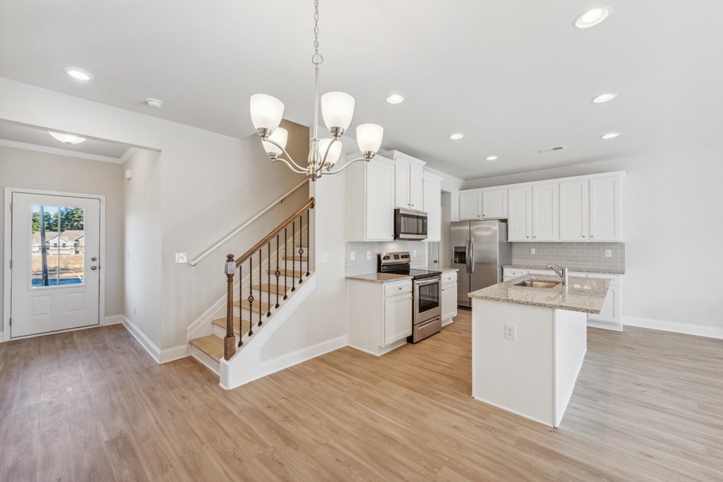 kitchen view with island and white color cabinets.
