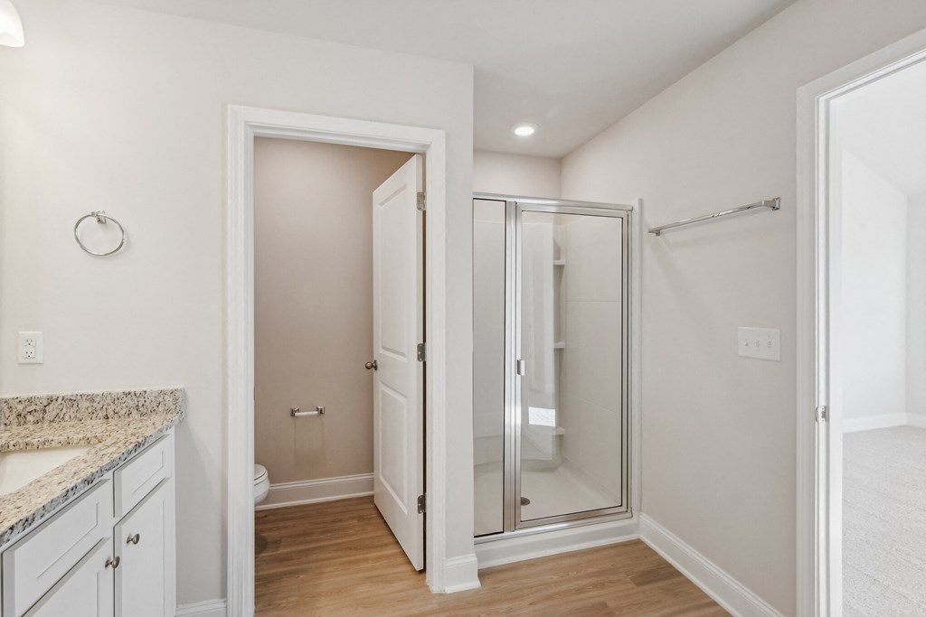 primary bathroom with stand up shower and water closet.