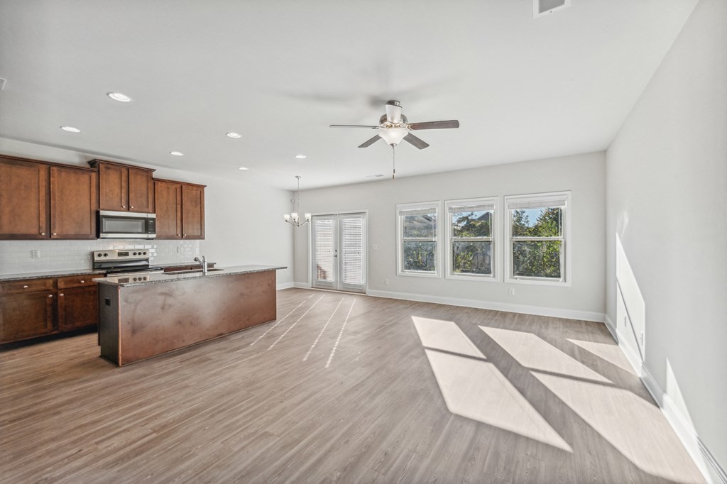 living room and kitchen view with espresso colored cabinets.