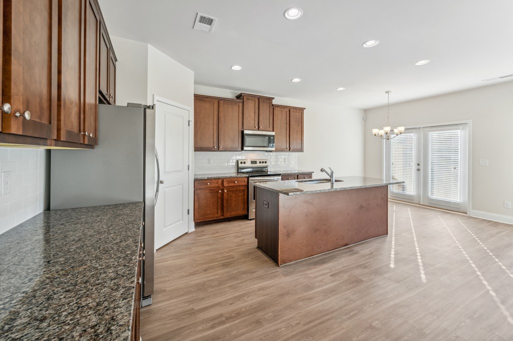 Kitchen with island and espresso colored cabinets