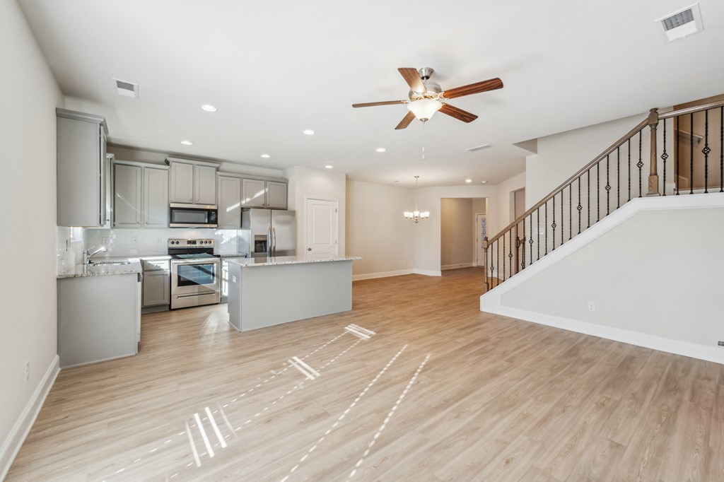 Kitchen view, with grey cabinets,  looking at stair way