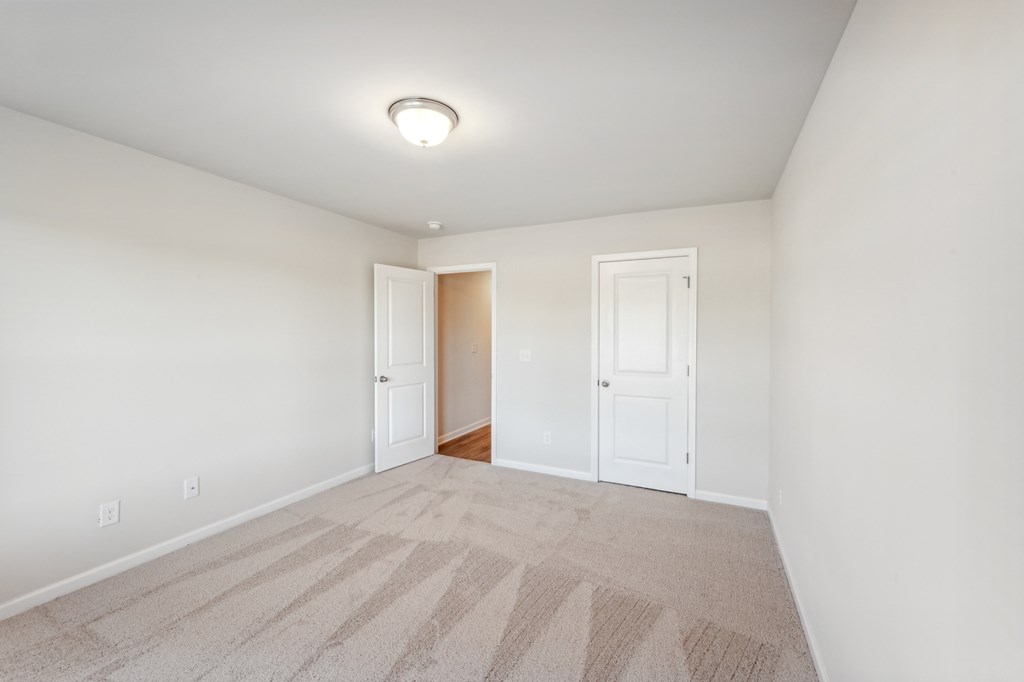 seconday bedroom with carpet