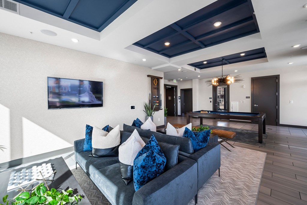 a living room with a couch and a pool table