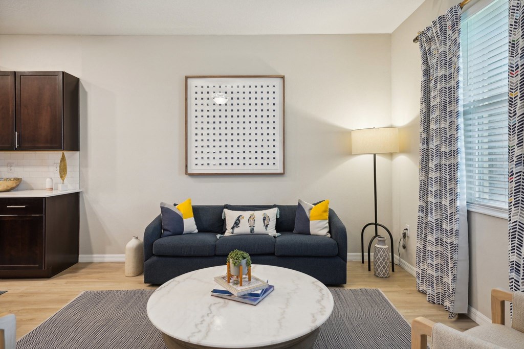 a living room with a blue couch and a coffee table