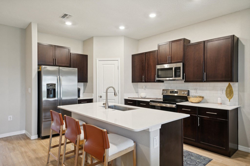 the reserve at city center spacious kitchen with island and stainless steel appliances
