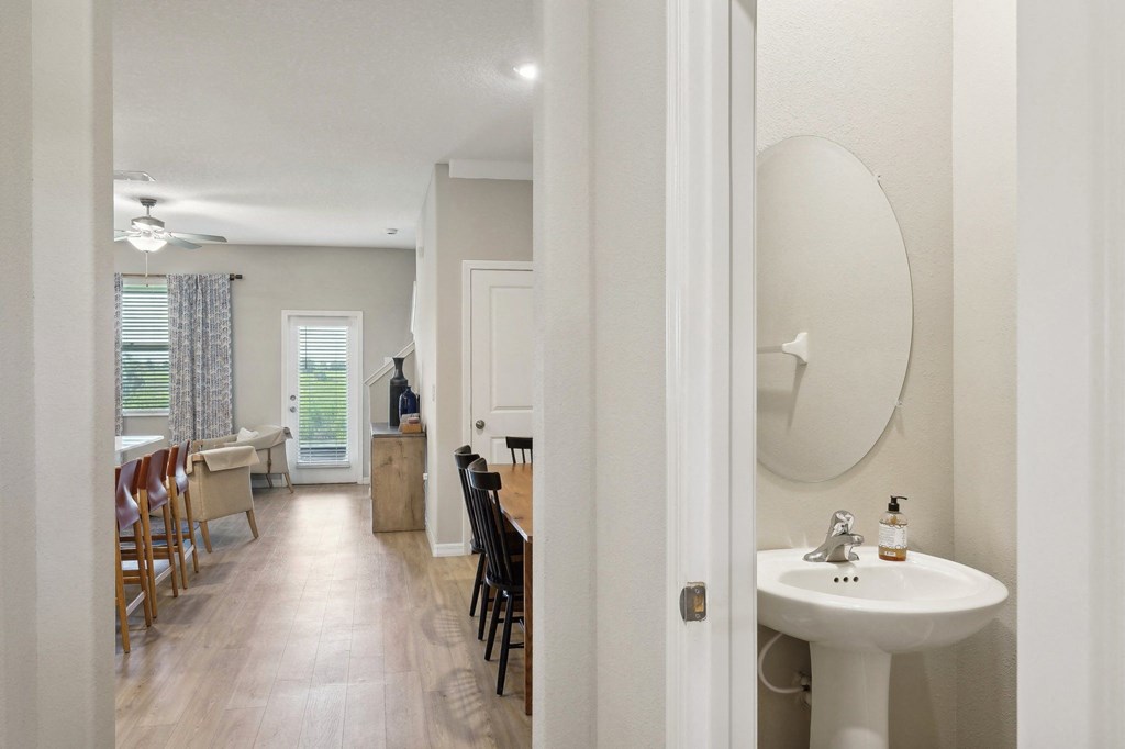 a view of a kitchen and a bathroom with a sink and a mirror
