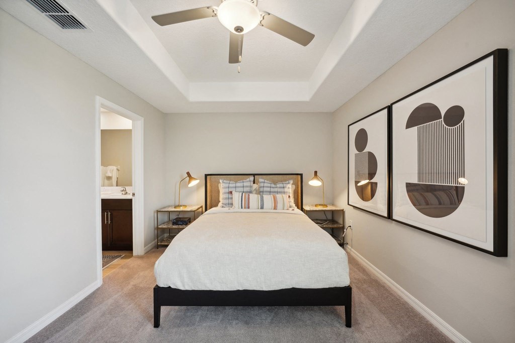 a bedroom with a bed and a ceiling fan