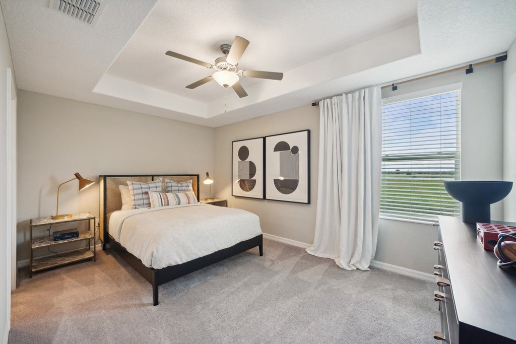 a bedroom with a bed and a ceiling fan