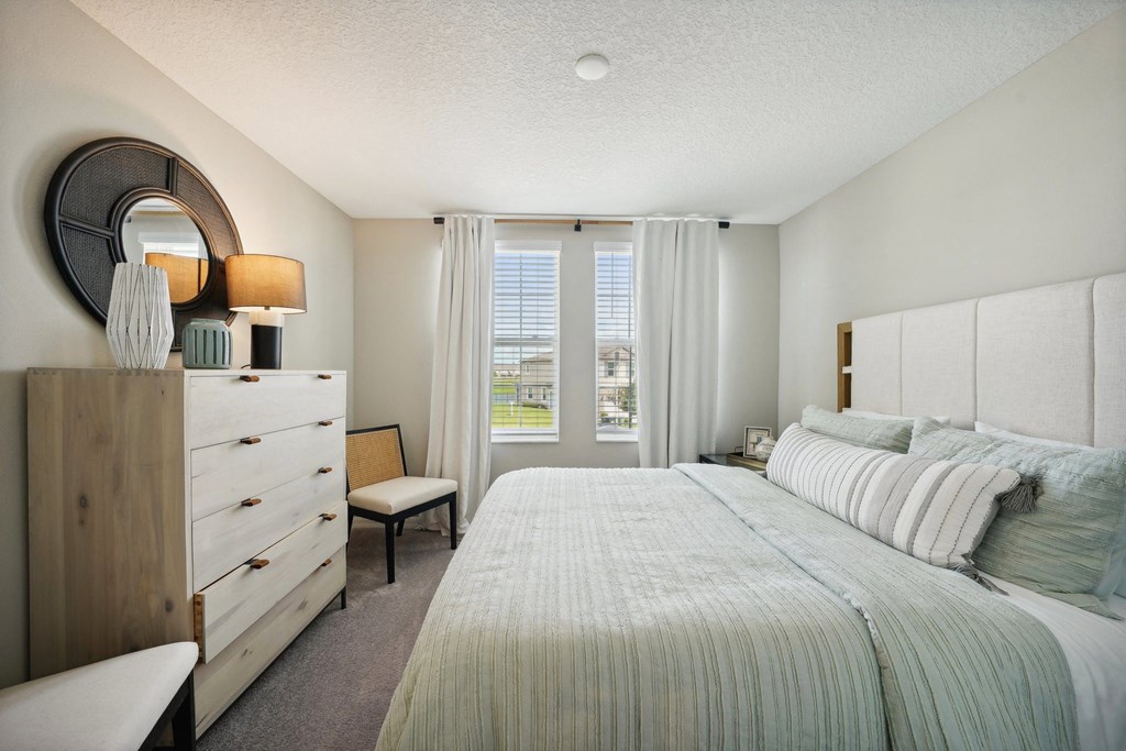 a bedroom with a large bed and a dresser