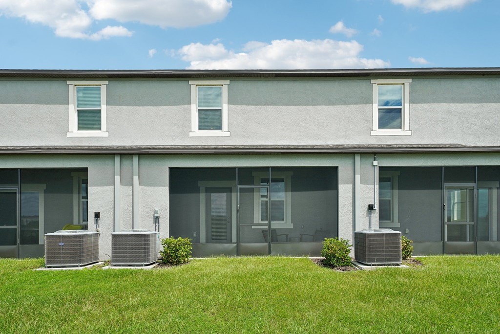 the front of a gray and with grass in front of it