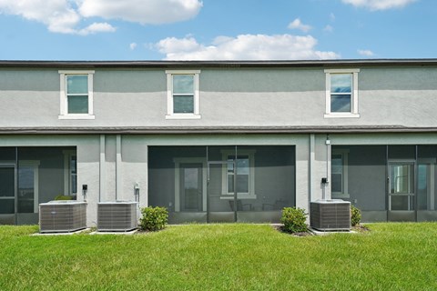 the front of a gray and with grass in front of it