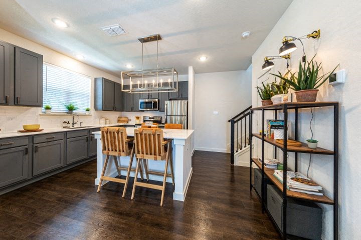a kitchen and dining room with a table and chairs