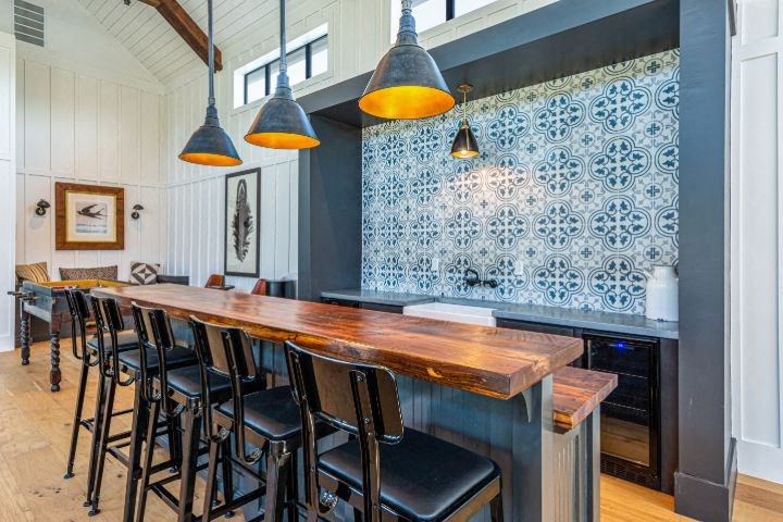 a long bar in a restaurant with black chairs