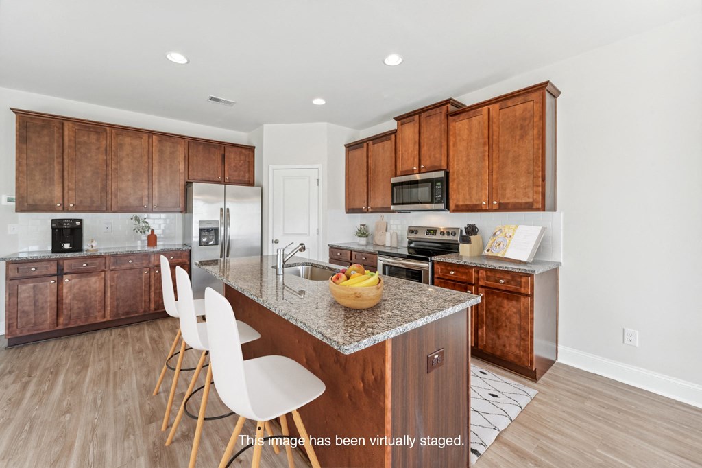 a kitchen with wooden cabinets and a granite counter top