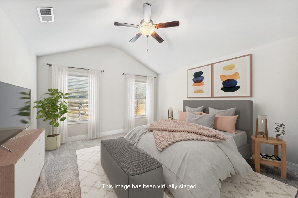 a bedroom with a bed and a ceiling fan