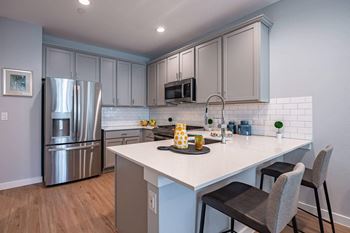 Fitted Kitchen With Island Dining at Villae ATX Luxury Rental Townhomes, Manchaca, TX