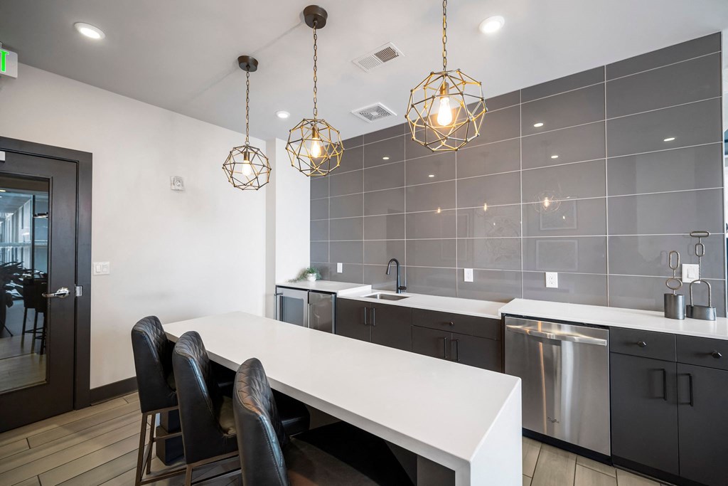 a kitchen with a white table and chairs