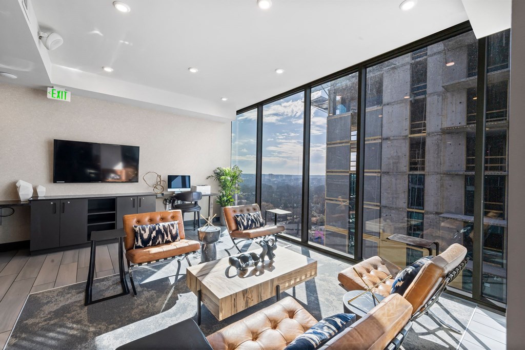 a living room with a large window and a television