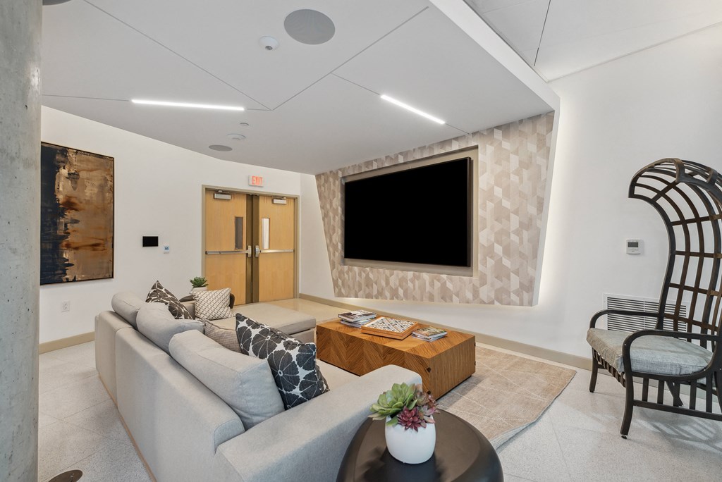 Living room with a couch and a television on the wall at K1 Apartments, San Diego, California