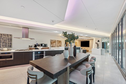 Large dining room with a long table and chairs at K1 Apartments, California, 92101