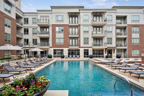 a swimming pool in front of an apartment building