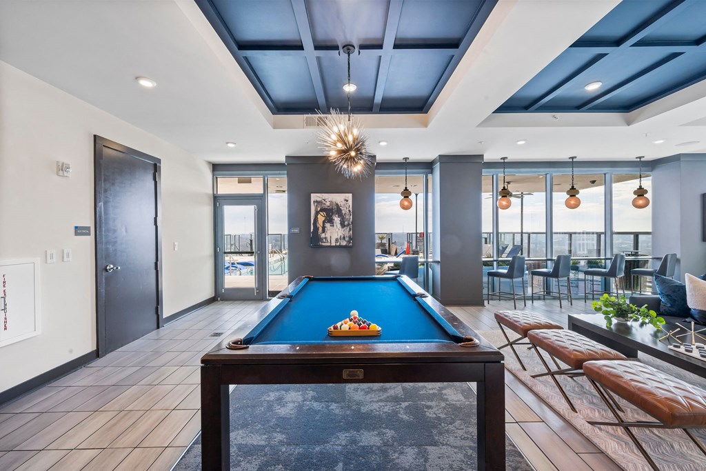 a game room with a pool table and chairs