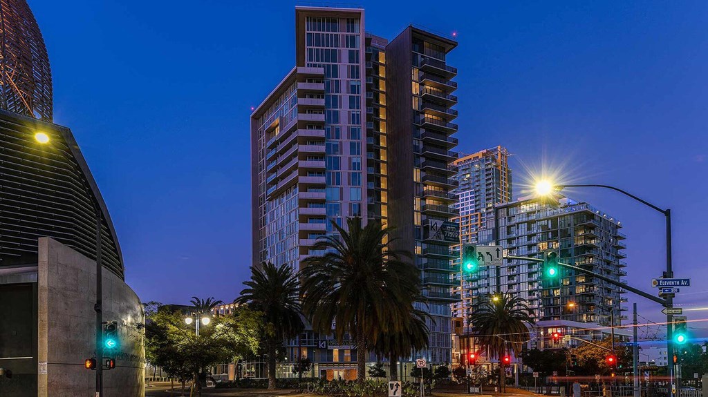 exterior view with night lights at K1 Apartments, San Diego, CA