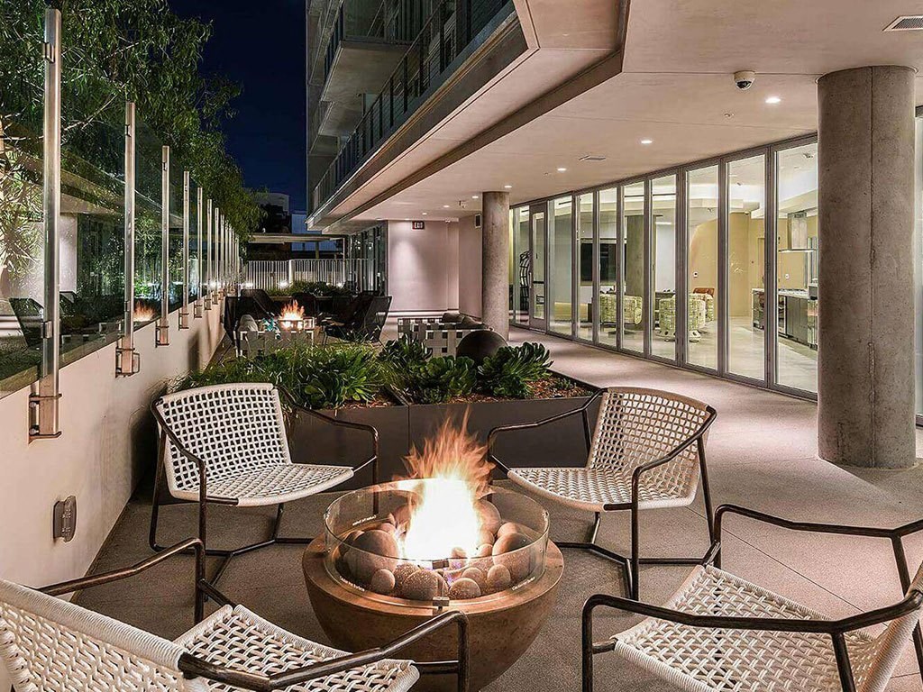 patio with glistening firepits at K1 Apartments, San Diego, CA 92101