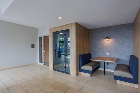 A room with a table and chairs and a glass door.