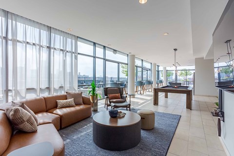 A living room with a brown sofa and a coffee table.