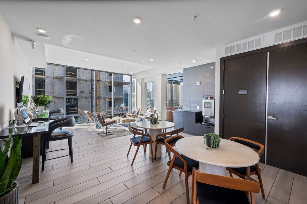 a living room with a table and chairs and a kitchen