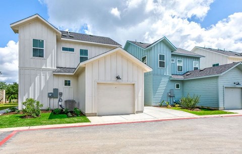 a row of blue and white houses next to a street