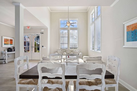 A dining room with a table and chairs.