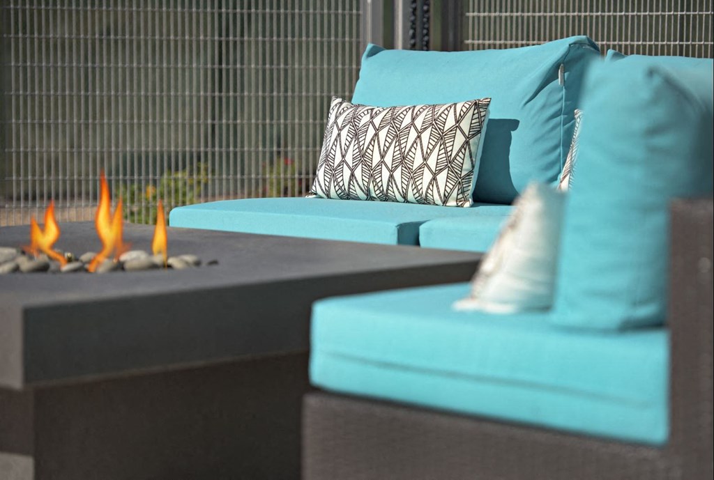 a living room with blue couches and a fire pit at Novella Arcadia, Phoenix, AZ 85018