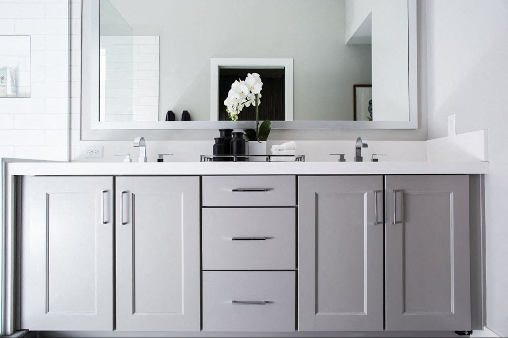 a bathroom with white cabinets and a sink and a mirror at Novella Arcadia, Arizona