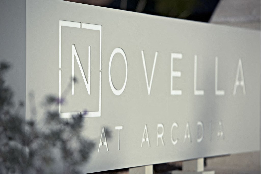a sign for novella in front of a building at Novella Arcadia, Phoenix, AZ 85018