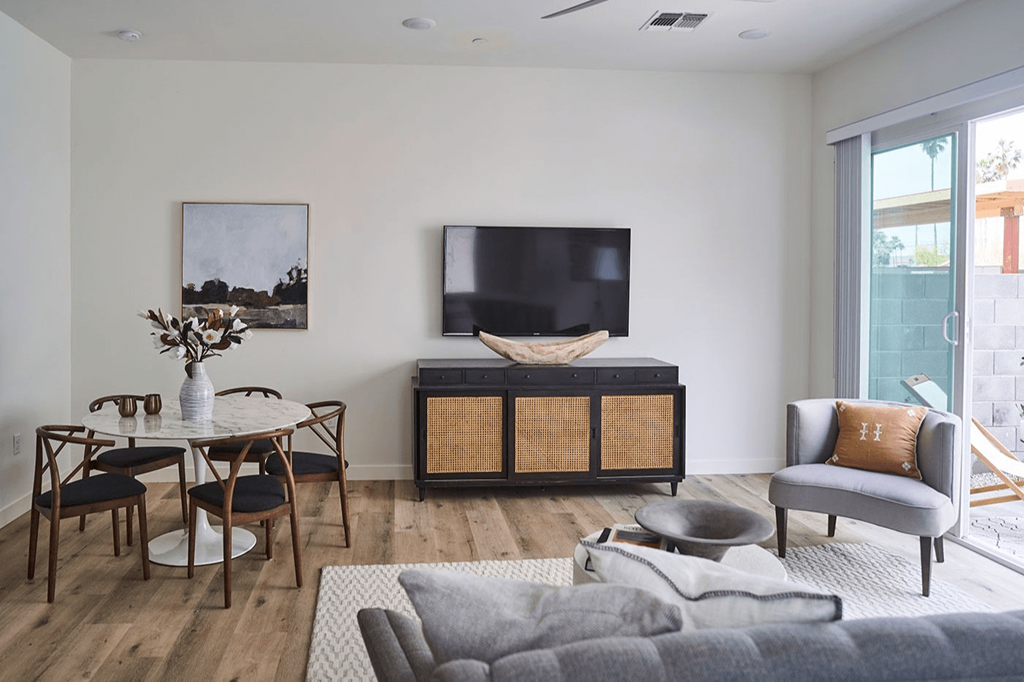 a living room with a couch and a table and a television at Novella Biltmore, Arizona, 85016
