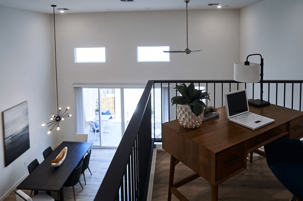 a living room with a desk with a laptop on it at Novella Biltmore, Phoenix Arizona