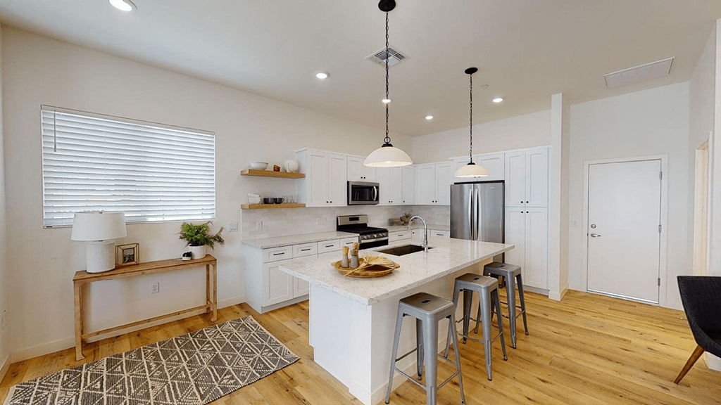 a kitchen with a large island with bar stools at Novella Biltmore, Phoenix, AZ 85016