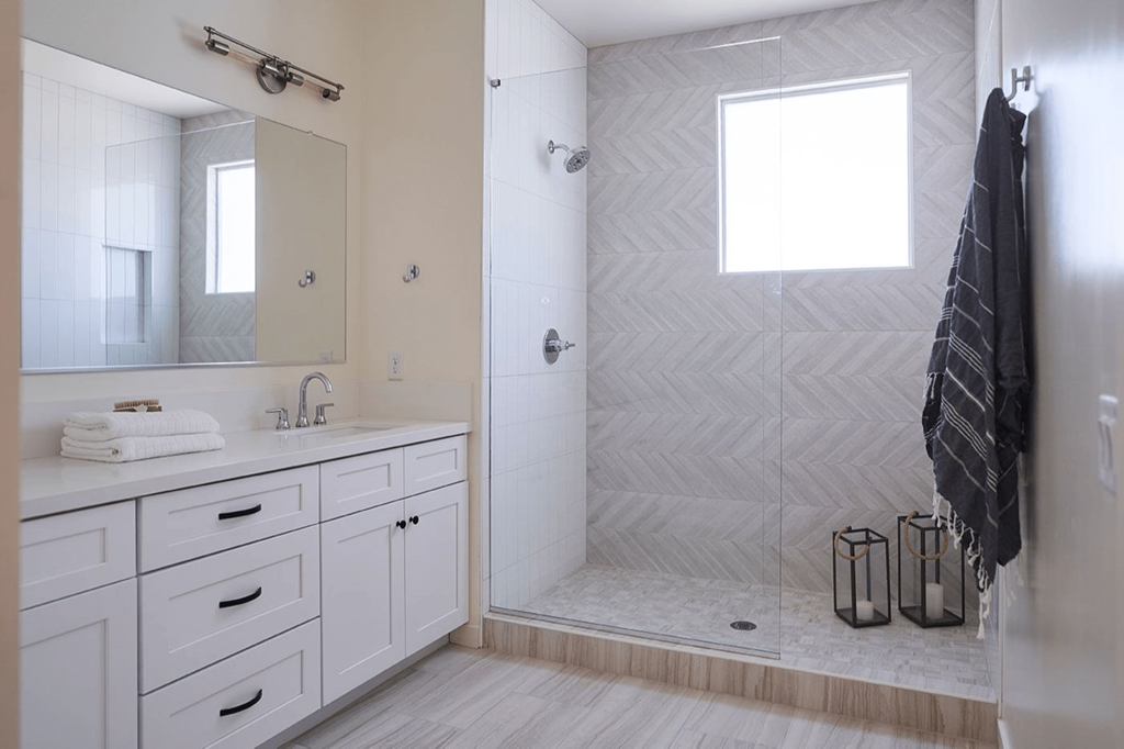 a white bathroom with a shower and a sink and a mirror at Novella Biltmore, Arizona