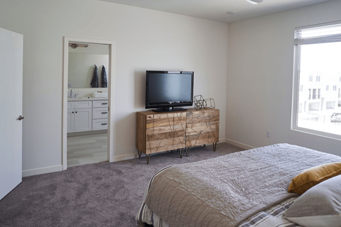 a bedroom with a bed and a television on a dresser at Novella Biltmore, Arizona, 85016